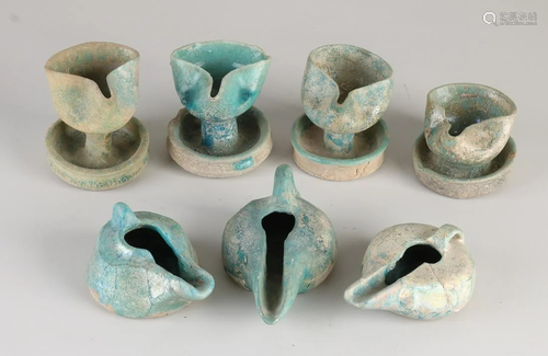 Seven antique glazed Nishapur terracotta oil lamps.