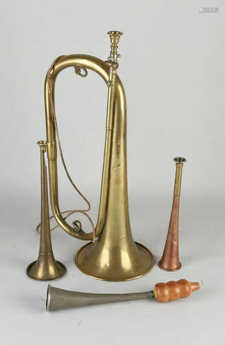 Four old/antique wind instruments, trumpets.