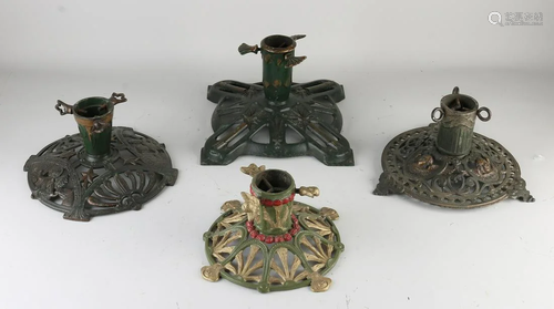 Four antique polychrome iron Christmas tree stands.