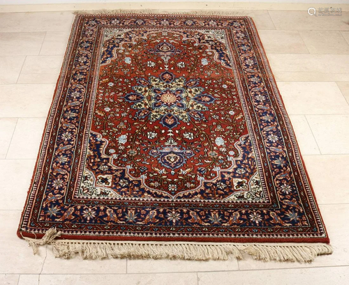 Old Persian rug with floral decor. Red/cream/black.