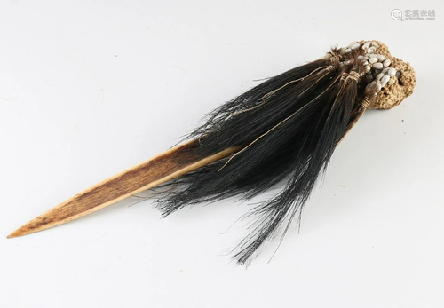 Ethnographic dagger made of bone and feathers. New