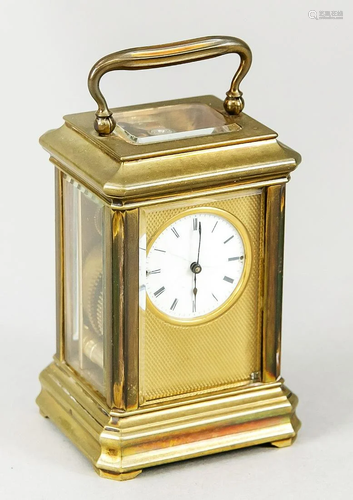 Old brass travel alarm clock with gold plating. Second