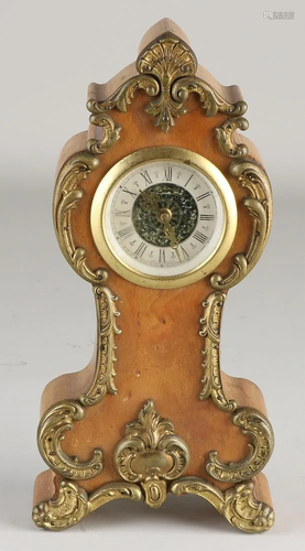 Walnut clock with brass fittings. Marked Jura West