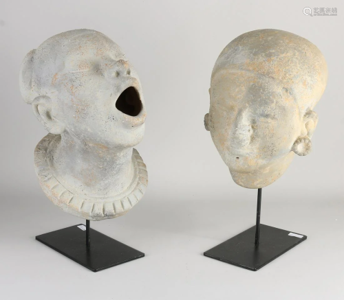 Two old Colombian terracotta cast death masks on stand.