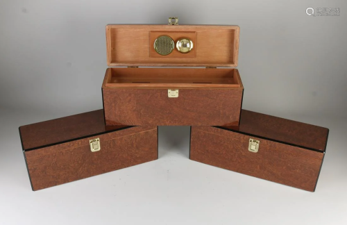 Three burr nut polished humidors. As new. Dimensions: