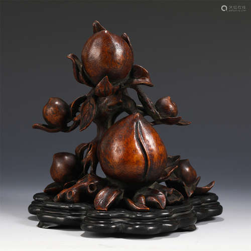 A Carved Chenxiang Peach Sculpture with Stand