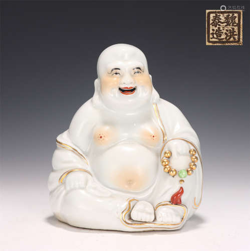 A White Glazed and Gilt Seated Budai