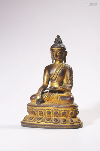 A GILT-BRONZE FIGURE OF SAKYAMUNI.MING PERIOD