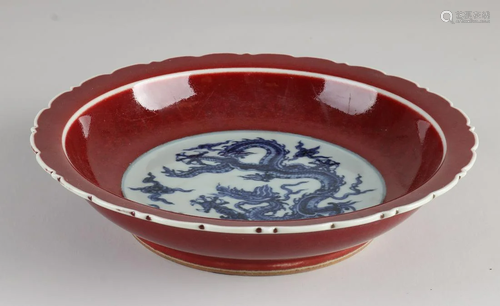 Chinese porcelain bowl with blue dragon and red glaze.