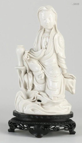 Chinese Blanc de Chine Quan Yin on wood-carved console.