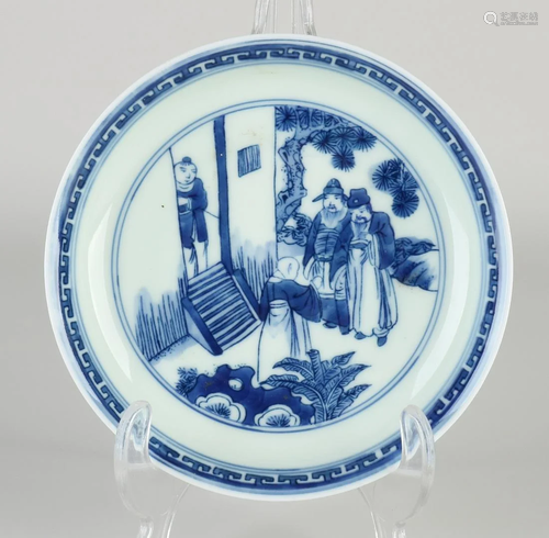 Chinese porcelain plate with figures in garden decor.