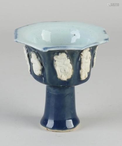 Chinese porcelain cup on a high foot with blue-green