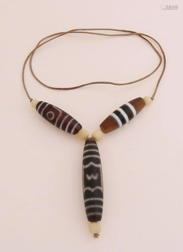 Necklace of leather cord with three old Chinese charm