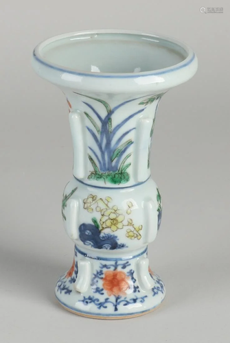 Chinese porcelain vase with ribs and floral decoration.