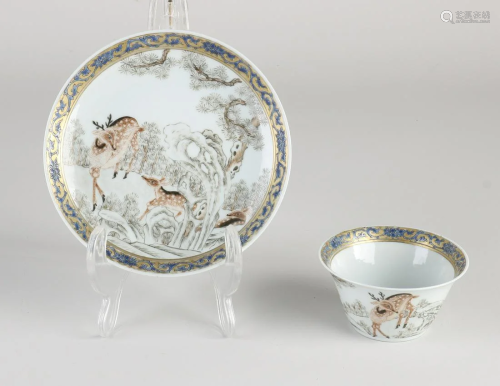 Chinese porcelain cup and saucer with deer in landscape