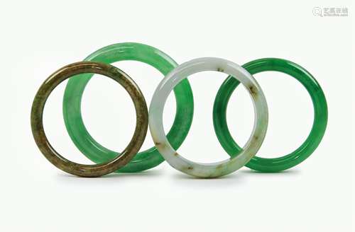 FOUR JADE / VARIED STONE BANGLES