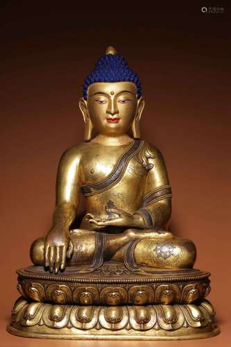 A seated statue of Sakyamuni inlaid with silver in bronze in...