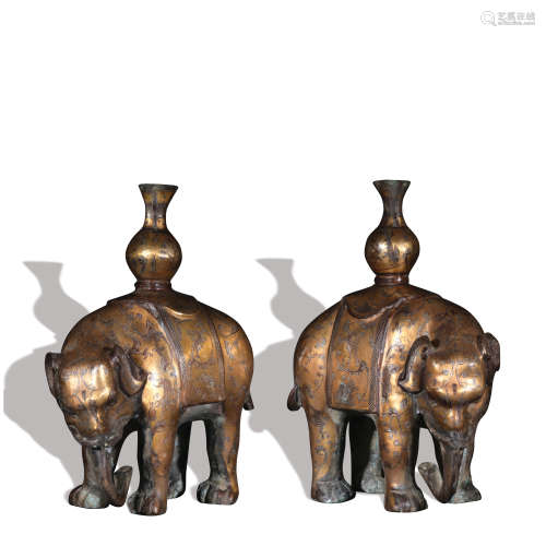 A pair of bronze elephant ware with silver