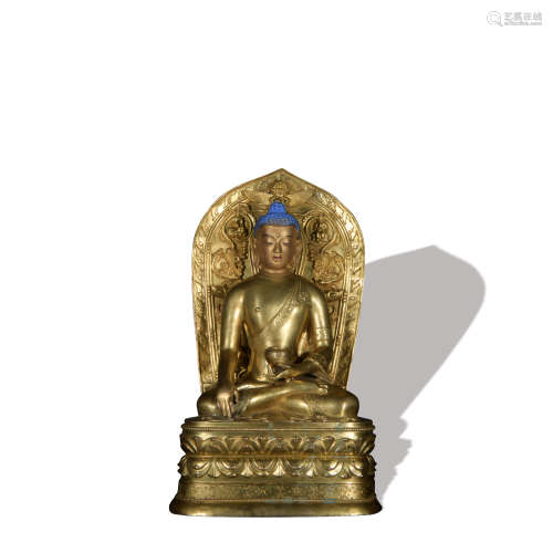 A gilt-bronze statue of Medicine Buddha