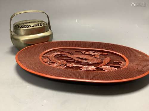 A Chinese lacquer and composition dish and a bronze hand war...