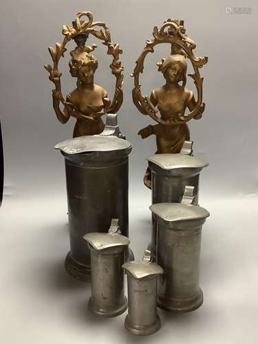 A set of five French pewter flagons and a pair of spelter la...