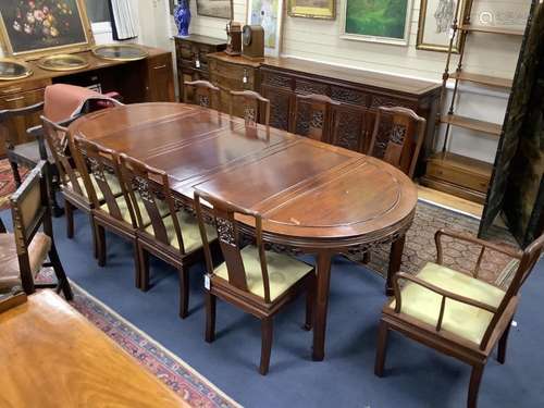 A 20th century Chinese carved hardwood dining room suite com...