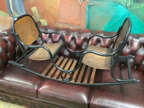 An early 20th century child's bentwood twin seat rocking cha...