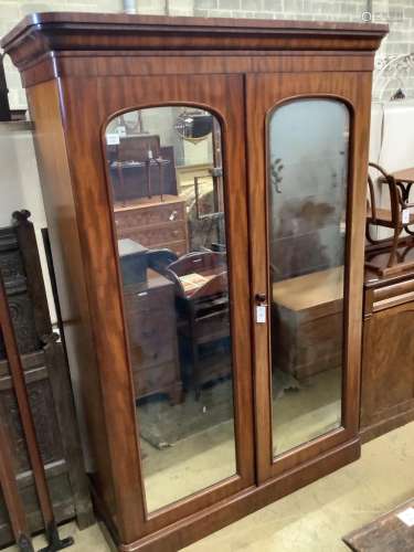 A Victorian mahogany mirrored two door wardrobe, width 142cm...