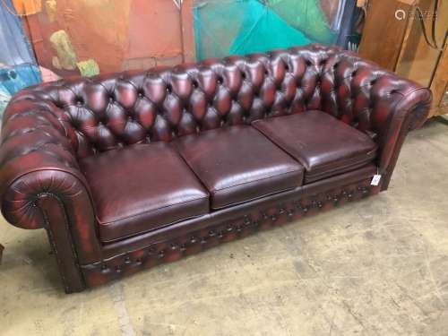 A Victorian style buttoned burgundy leather three seater Che...
