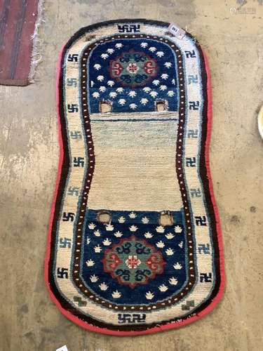 A Tibetan saddle rug, pre 1905, 120 x 60cm