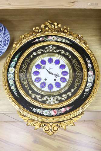 A floral painted clock, length 63cm, quartz movement