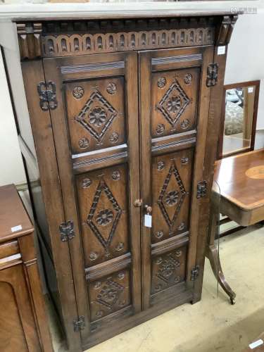 An 18th century style carved panelled oak wardrobe, width 95...