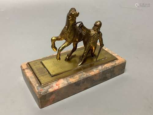 An early 20th century gilt metal group of a horse and jockey...