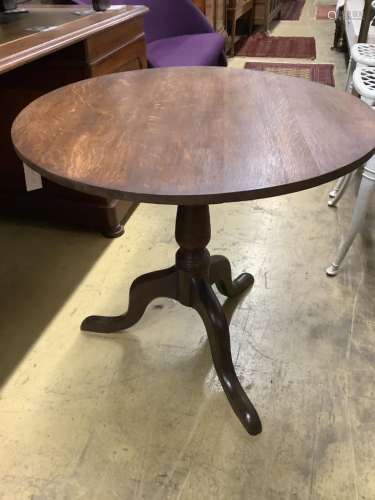A George III oak circular tilt top tea table, diameter 75cm ...