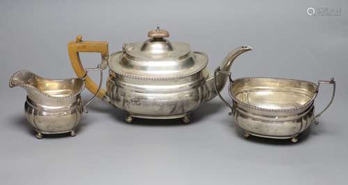 A George V three piece silver tea set, Harrod's Ltd, London,...