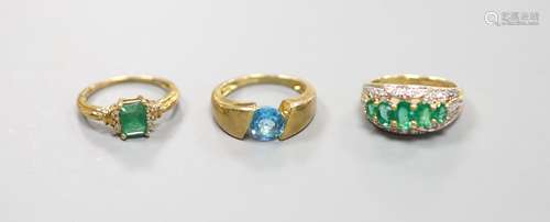 Two 9ct gold emerald-set rings and another 9k gem-set ring,g...