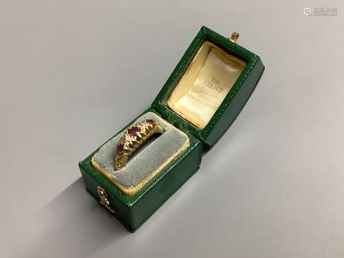 An Edwardian 18ct gold, three stone ruby and two stone diamo...