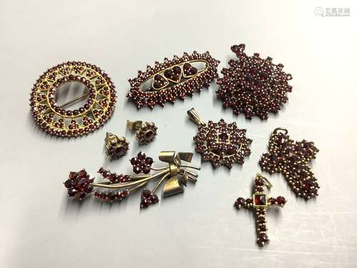 A group of facetted garnet set jewellery, including brooches...