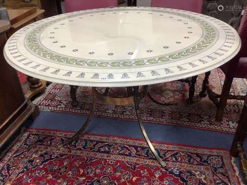 A modern circular dining table, with faux marble top on gilt...