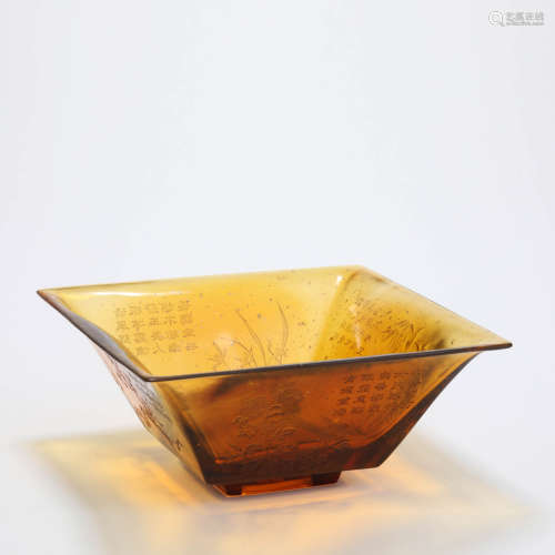 An inscribed brown glass flaring square bowl