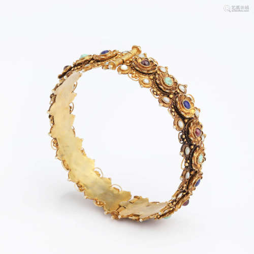 A gems and gold inlaid bronze bangle