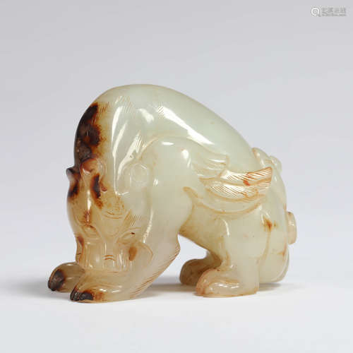 A carved white and russet jade mythical beast