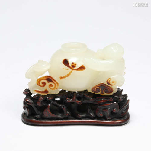 A carved white jade figural water coupe with sandalwood stan...