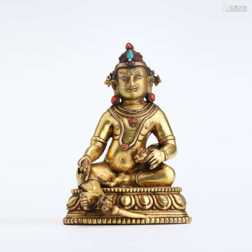 A gems inlaid and gilt bronze seated statue of yellow jambha...