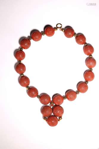 A CINNABAR LACQUER 'LONGEVITY' BEAD BRACELET