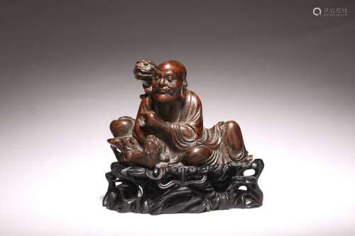 A CHINESE CHENGXIANGMU CARVED TIGER TAMING ARHAT