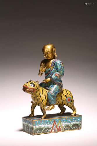 A CHINESE CLOISONNE ENAMEL FIGURE OF MONK ON TIGER