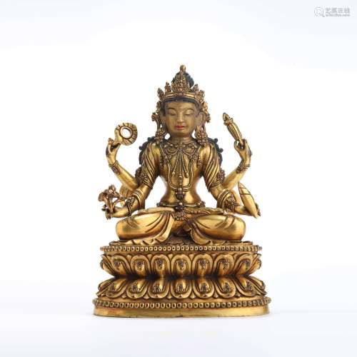 A gilt bronze seated statue of four-arm avalokitesvara