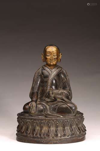 A TIBETAN GILT PAINTED BRONZE SILVER INLAID LAMA