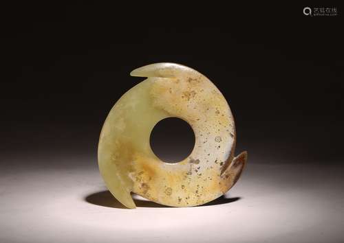 AN ARCHAIC CHINESE CELADON JADE XUANJI DISC